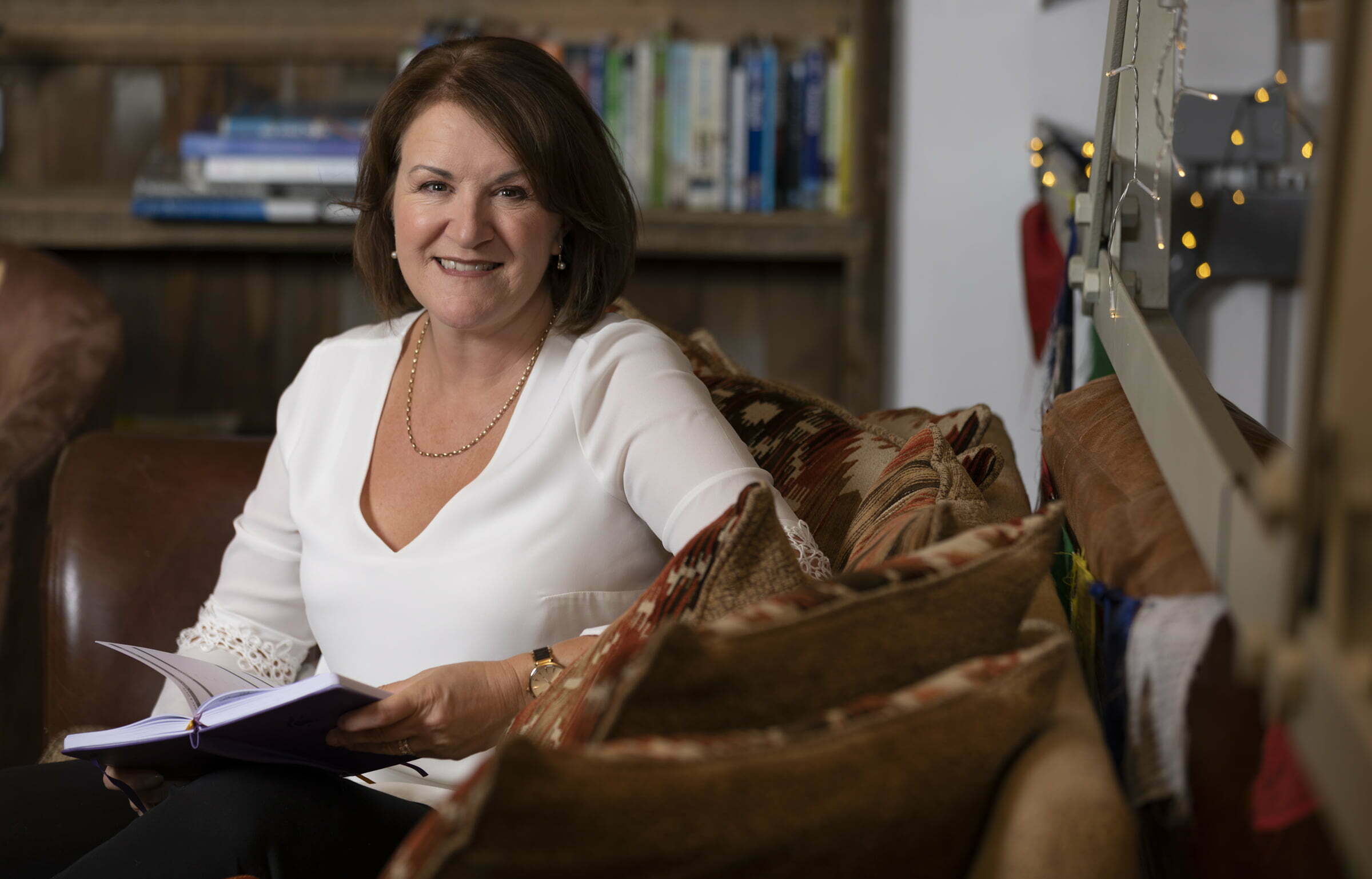 Louise Jenner smiling holding a book