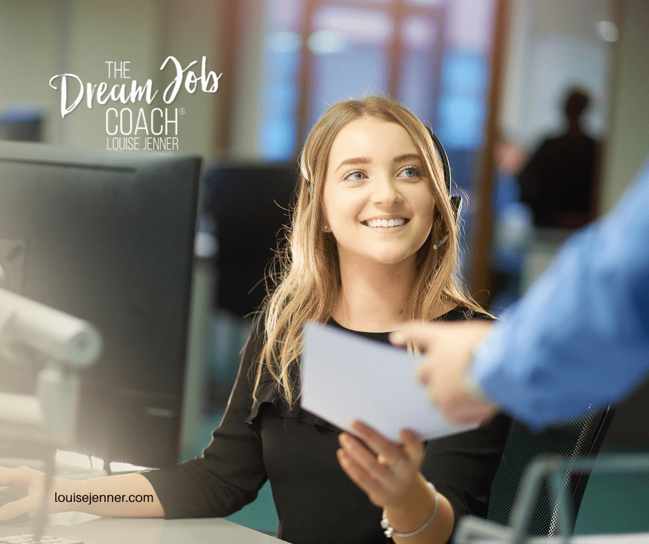 women on a phone call working at her desk in an office