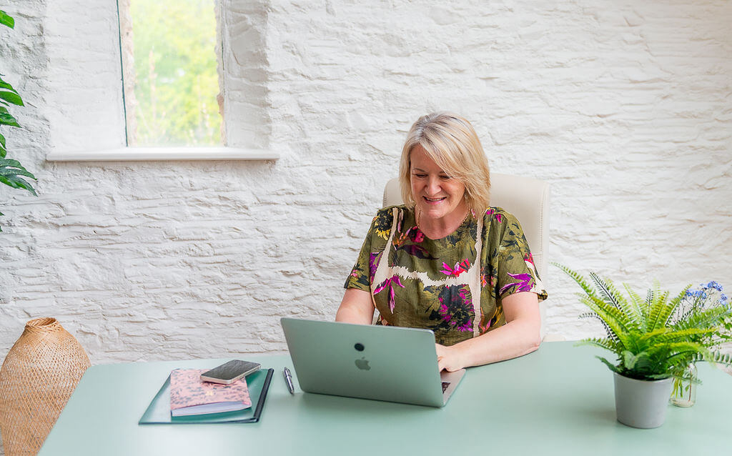 Louise Jenner working on her laptop, writing the Dream Job Blog.