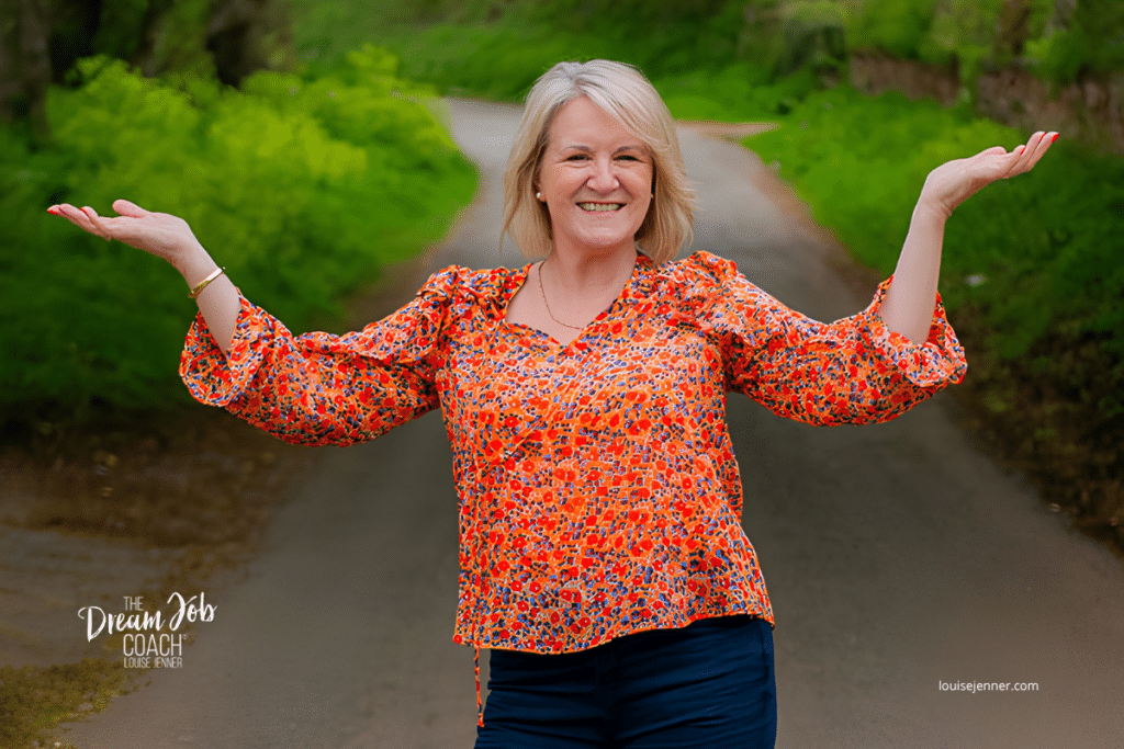 Louise Jenner, The Dream Job Coach, standing on a country lane with her arms outstretched, symbolising choice, freedom and designing your own path.