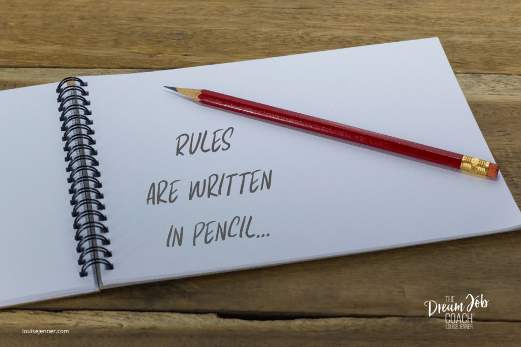 A sharpened red pencil resting on an open notebook displaying the words "Rules are written in pencil", symbolising flexibility and adapting as life changes.