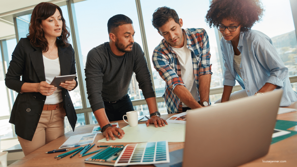 Small team of four people working together around a table.